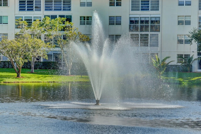 view of community featuring a water view and a yard