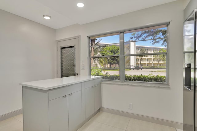 interior space featuring kitchen peninsula and light tile patterned floors