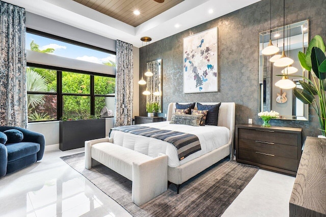 bedroom with a high ceiling and a tray ceiling