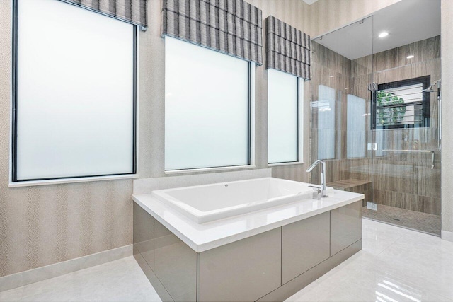 bathroom featuring tile patterned flooring and separate shower and tub