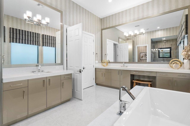 bathroom with tile patterned flooring, a bathtub, and vanity