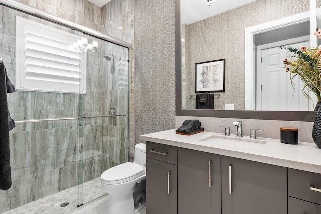 bathroom with vanity, an enclosed shower, and toilet