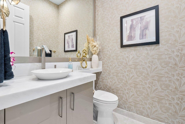 bathroom featuring tile patterned floors, vanity, and toilet