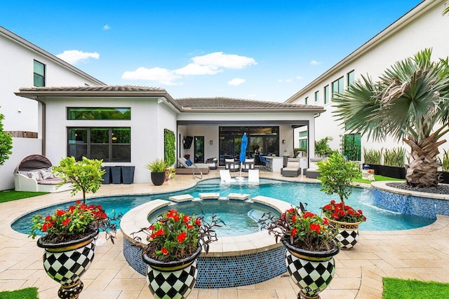 view of pool featuring pool water feature, an in ground hot tub, and a patio