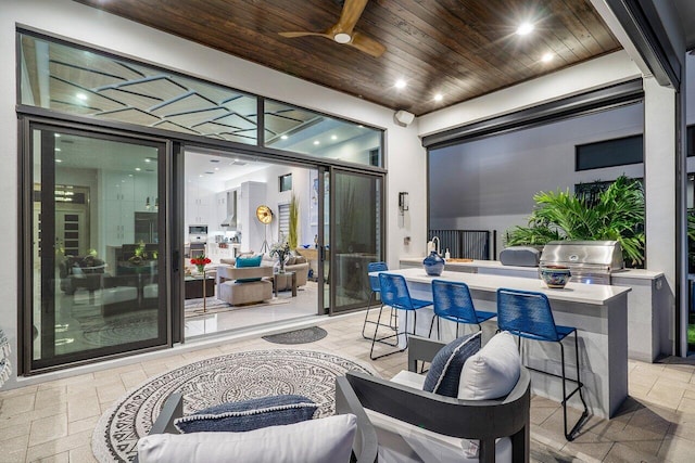 view of patio / terrace with ceiling fan, area for grilling, an outdoor bar, and an outdoor kitchen