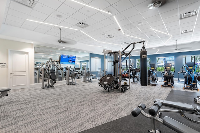 gym with carpet flooring and a paneled ceiling