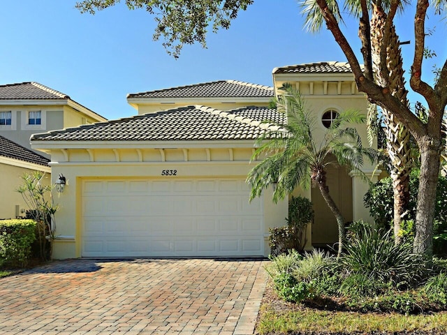 mediterranean / spanish home featuring a garage