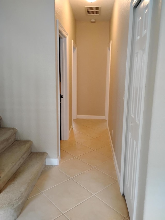 corridor with light tile patterned floors