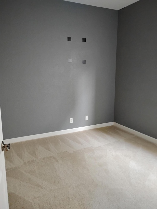 unfurnished room with light colored carpet