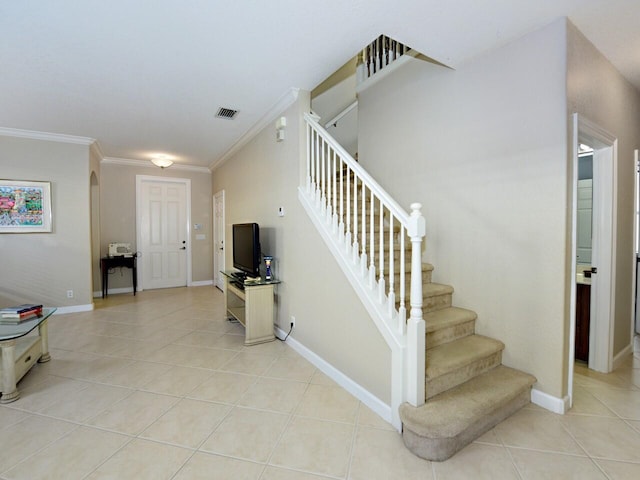 staircase with tile patterned flooring and crown molding