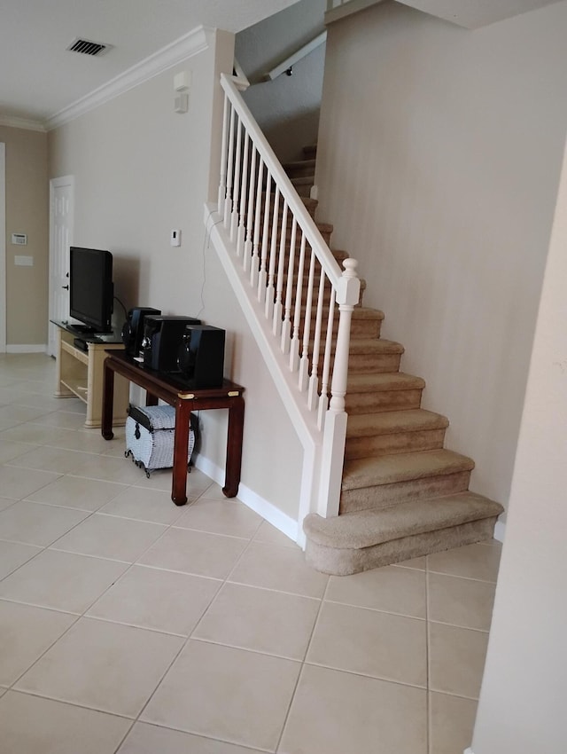 stairway featuring tile patterned floors and ornamental molding