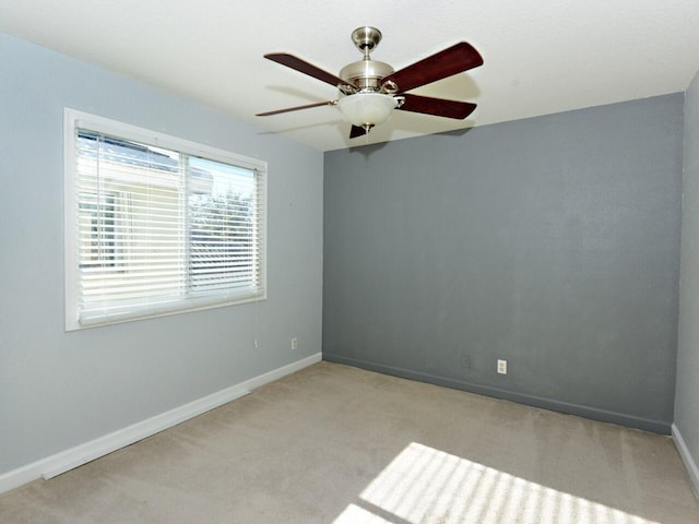 empty room featuring light carpet and ceiling fan