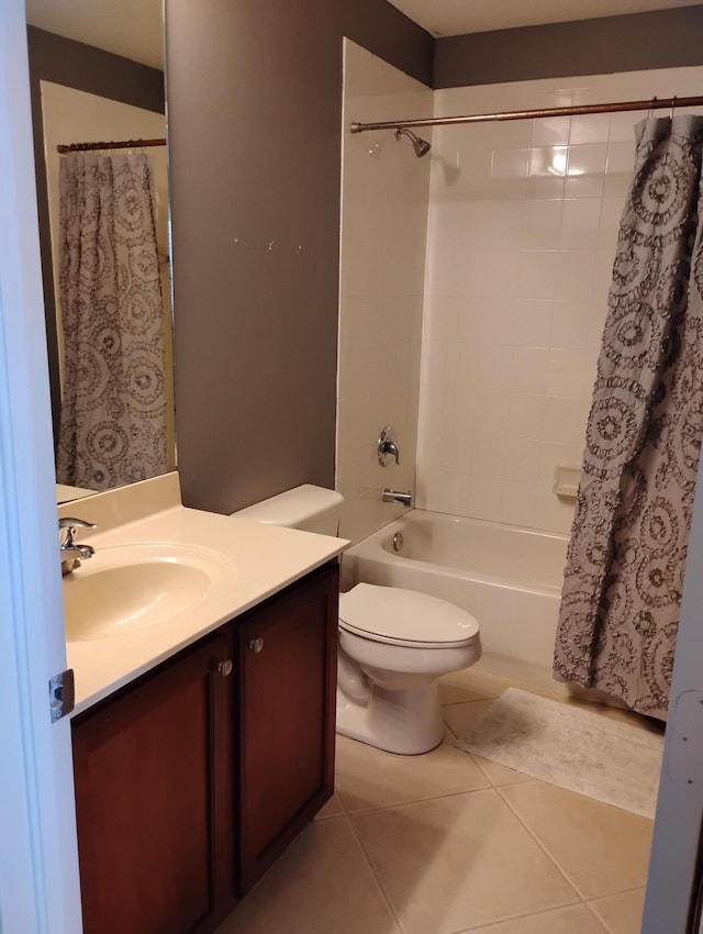 full bathroom featuring toilet, vanity, shower / bathtub combination with curtain, and tile patterned flooring