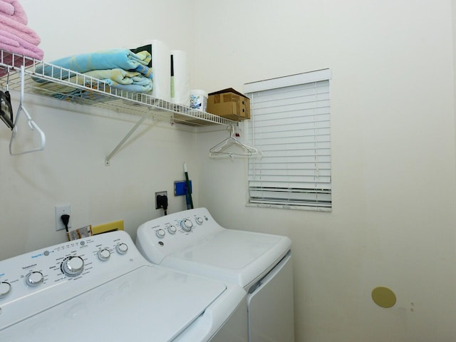 clothes washing area with washing machine and dryer