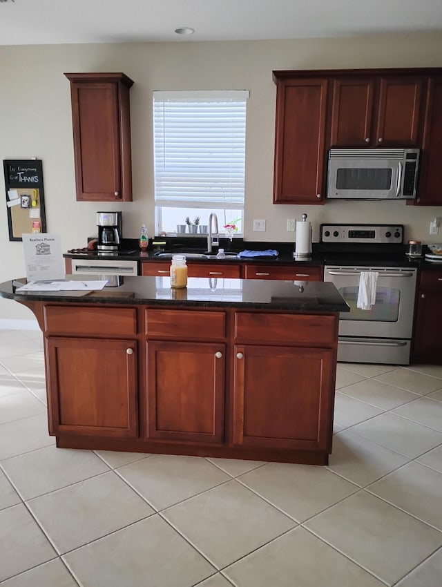 kitchen featuring stainless steel appliances, light tile patterned flooring, and sink