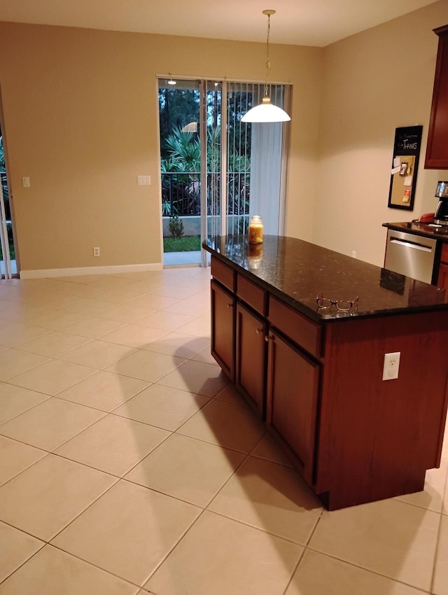 kitchen featuring light tile patterned floors, dark stone countertops, hanging light fixtures, a kitchen island, and stainless steel dishwasher