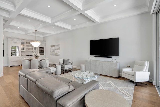 living room with light wood-type flooring, coffered ceiling, a notable chandelier, and beam ceiling