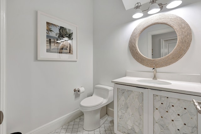 bathroom featuring toilet and vanity