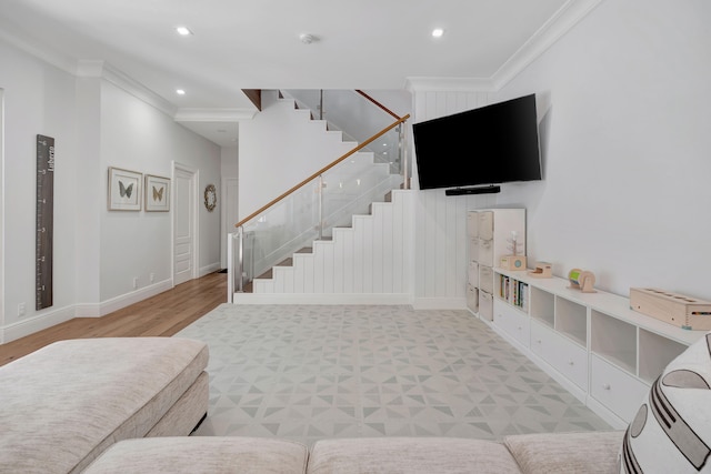 living room with light wood-type flooring and ornamental molding