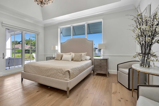 bedroom with ornamental molding, access to outside, light hardwood / wood-style floors, and vaulted ceiling