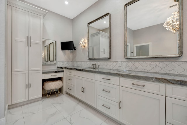 bathroom with vanity and decorative backsplash