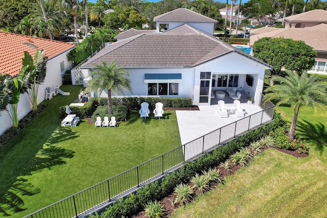 rear view of property with a patio area and a yard