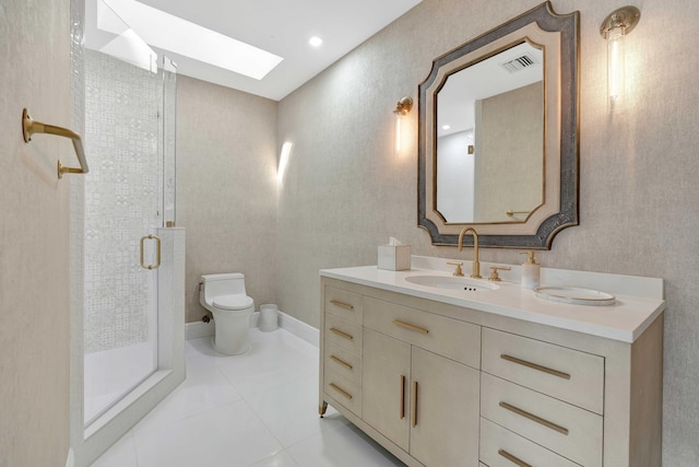 bathroom featuring walk in shower, vanity, tile patterned flooring, toilet, and a skylight