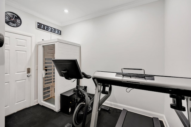 workout room featuring crown molding