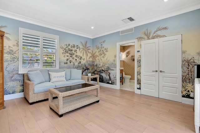 living room featuring ornamental molding and light hardwood / wood-style flooring