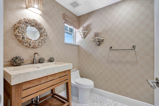 bathroom with vanity, tile patterned floors, and toilet