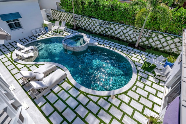 view of pool with a patio and an in ground hot tub