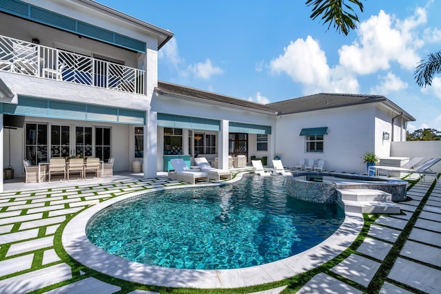 view of pool featuring an outdoor living space, a patio, and an in ground hot tub