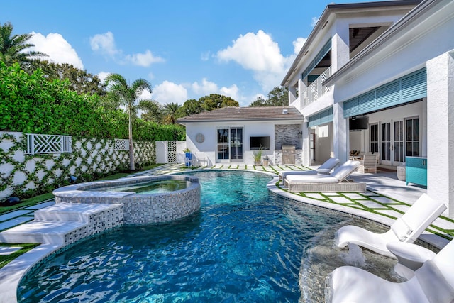 view of swimming pool featuring a patio and an in ground hot tub