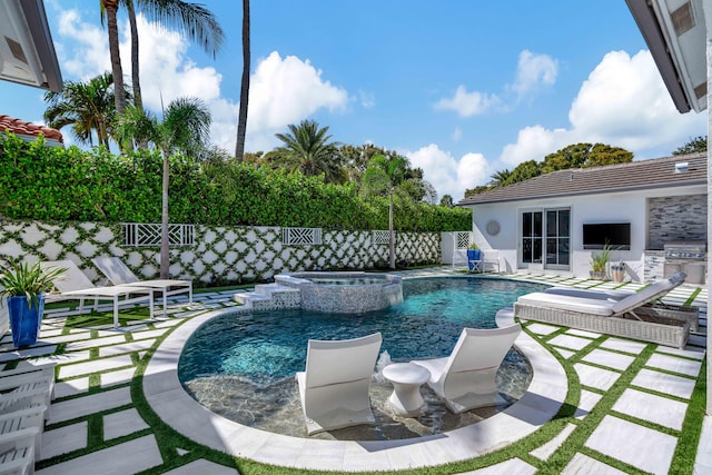 view of pool featuring a patio and an in ground hot tub