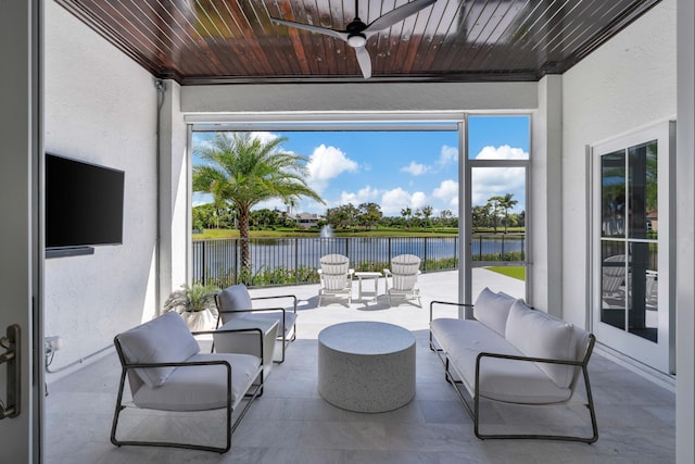 sunroom / solarium featuring a water view, wooden ceiling, and ceiling fan