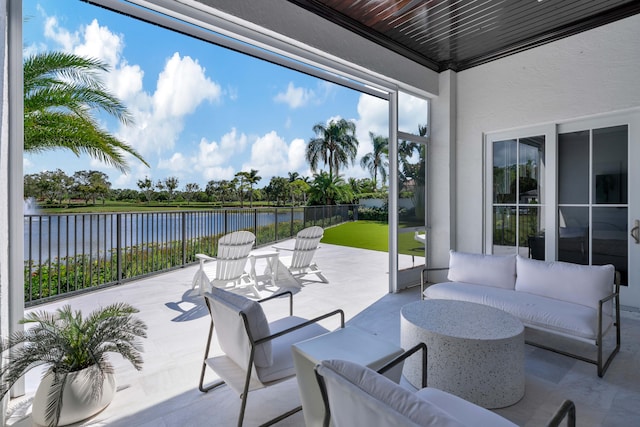 view of patio / terrace with outdoor lounge area and a water view