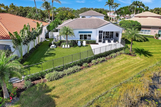 back of house with a lawn