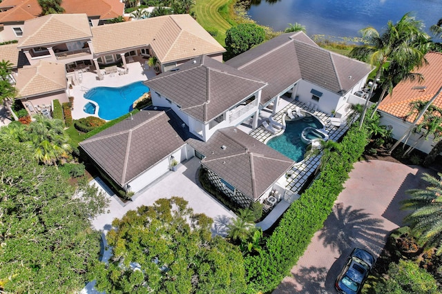 birds eye view of property with a water view