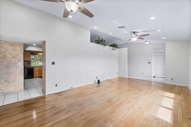 spare room featuring ceiling fan, light hardwood / wood-style floors, and vaulted ceiling