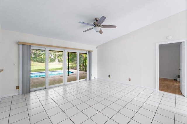 tiled empty room with ceiling fan and lofted ceiling