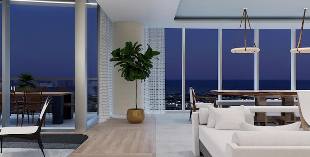 bedroom with hardwood / wood-style flooring and a water view