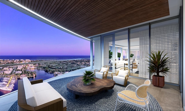 balcony at dusk with outdoor lounge area and a water view