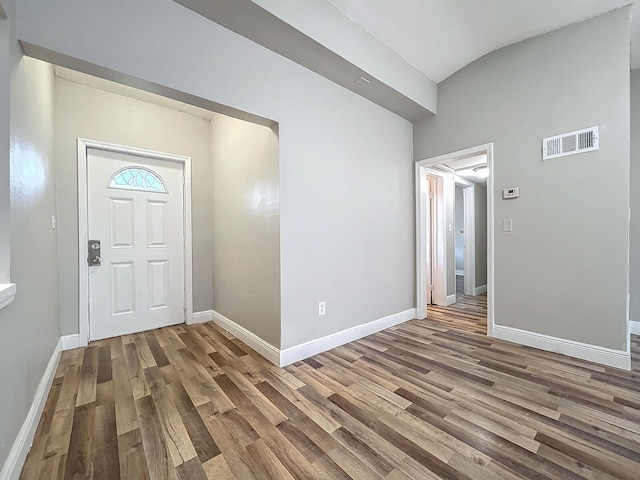 foyer with lofted ceiling and hardwood / wood-style flooring