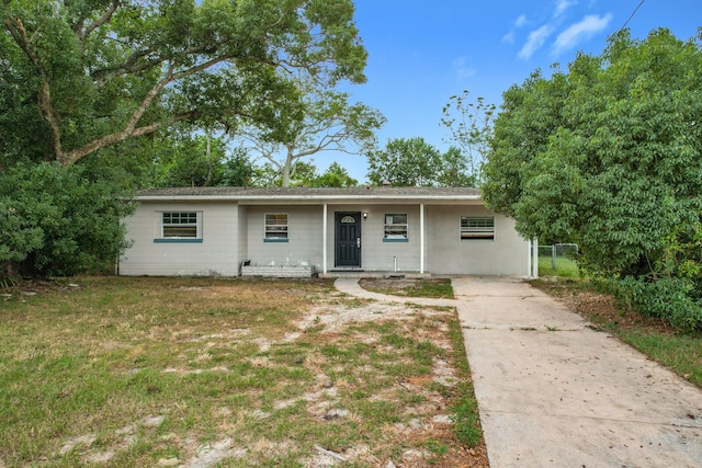 ranch-style home with a front yard and covered porch