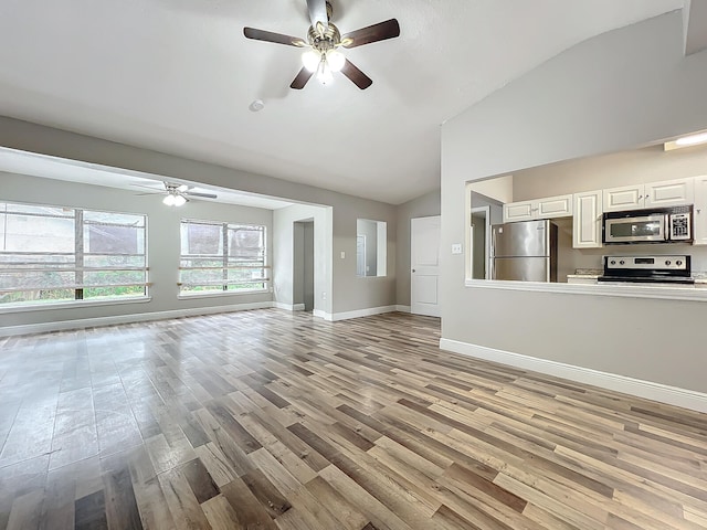 unfurnished living room featuring light hardwood / wood-style flooring, lofted ceiling, and ceiling fan