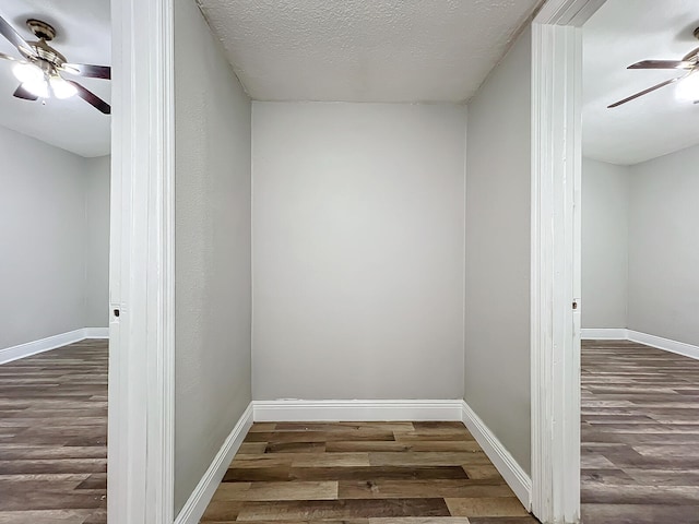 interior space featuring ceiling fan, a textured ceiling, and dark hardwood / wood-style flooring