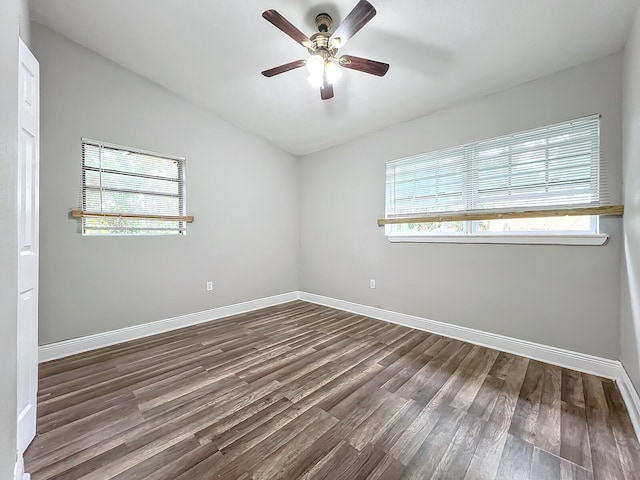 unfurnished room with dark wood-type flooring, ceiling fan, and vaulted ceiling