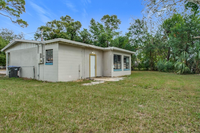 back of property featuring a lawn