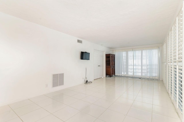 empty room with light tile patterned floors