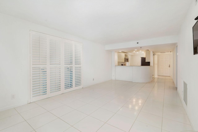 unfurnished living room with light tile patterned flooring